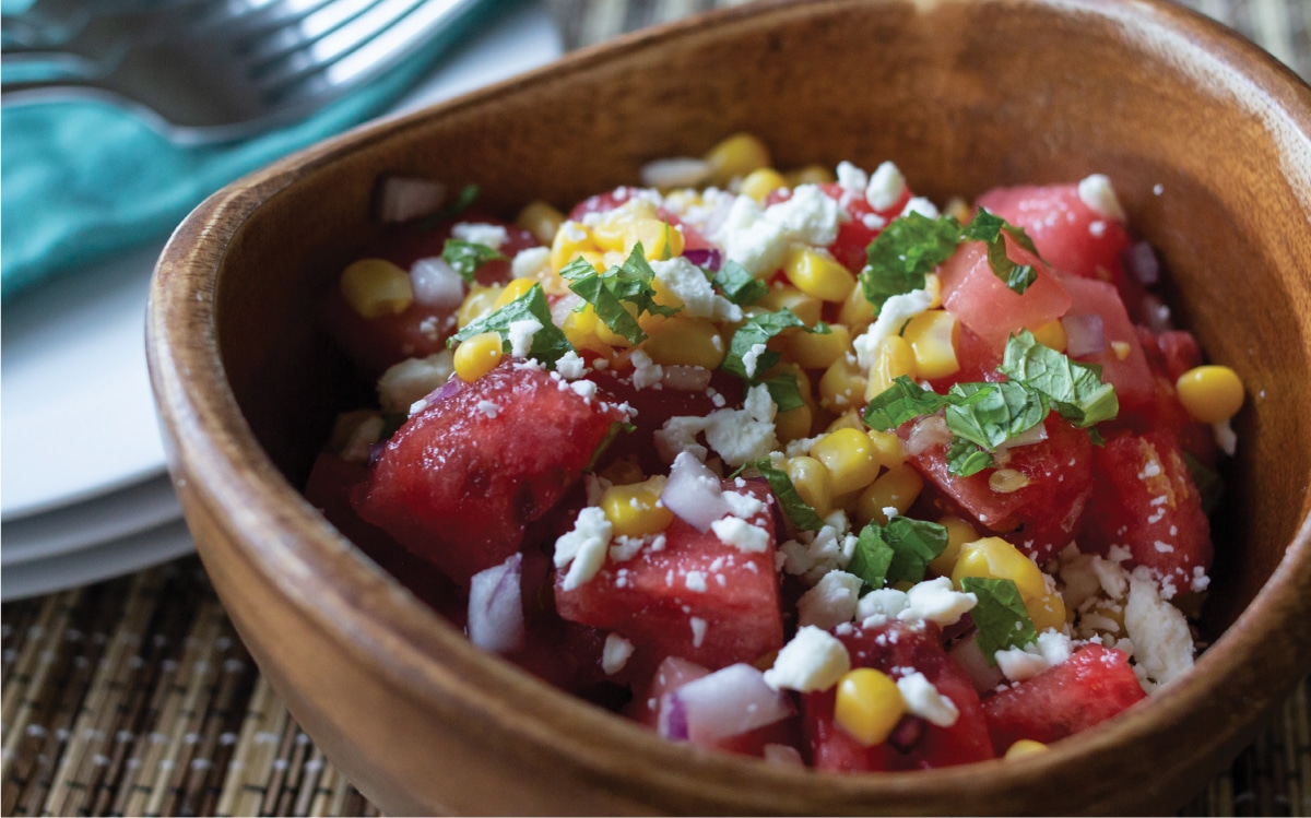 refreshing watermelon and corn salad in a wooden bowl