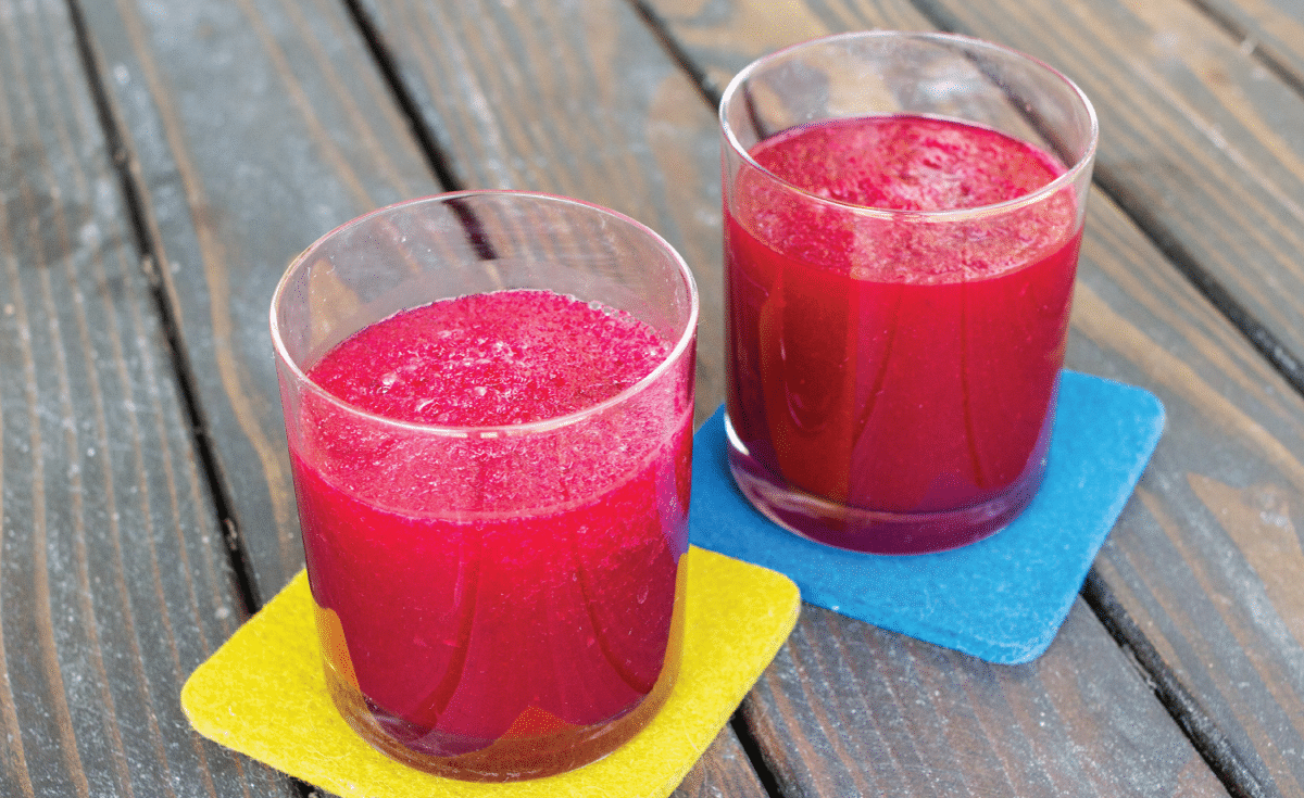 Vibrant Beet Smoothie in two glasses on yellow and blue napkins
