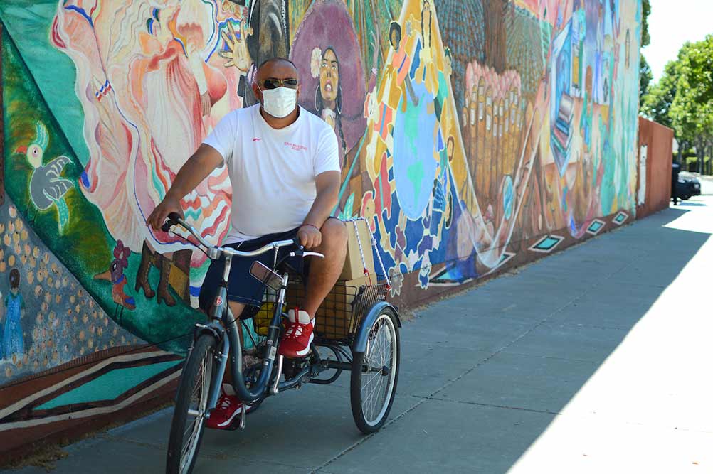 Roberto’s bike was a cargo trailer where he could stack all the boxes of food he received for his seven-person household