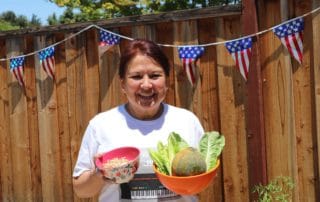 Colette in her backyard with fresh produce