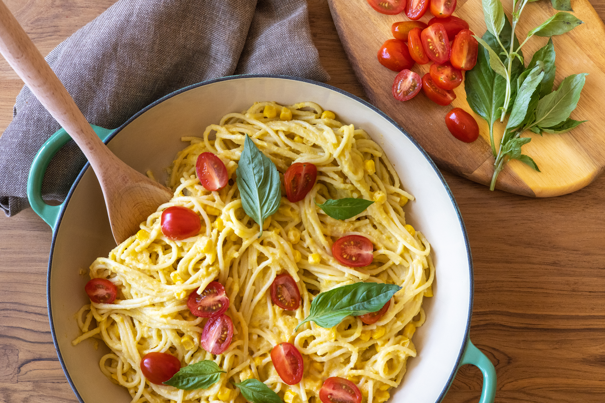 Spaghetti in a pot with corn and tomatoes