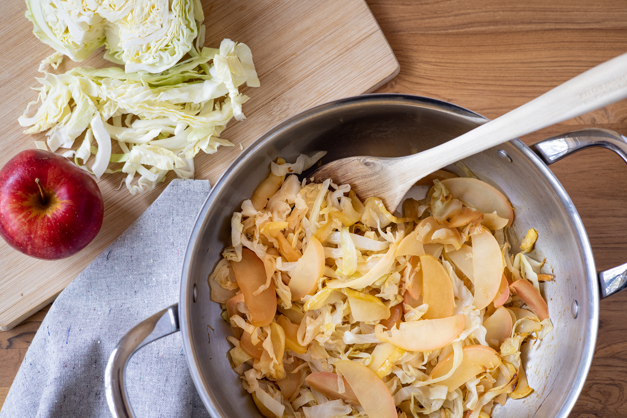Sliced apples and shredded cabbage in a pot