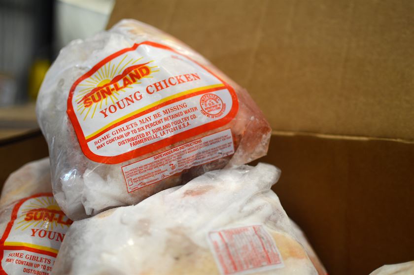 A box of frozen chickens ready to be sorted, bagged and distributed to our clients and partner organizations.