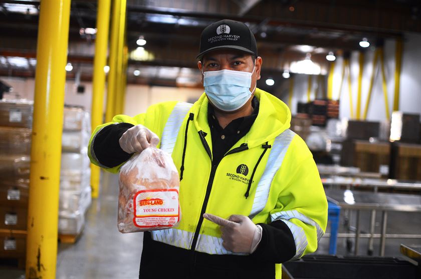 Second Harvest of Silicon Valley staff, Sokhom Han, began his morning shift preparing the warehouse floor for volunteer food sorting